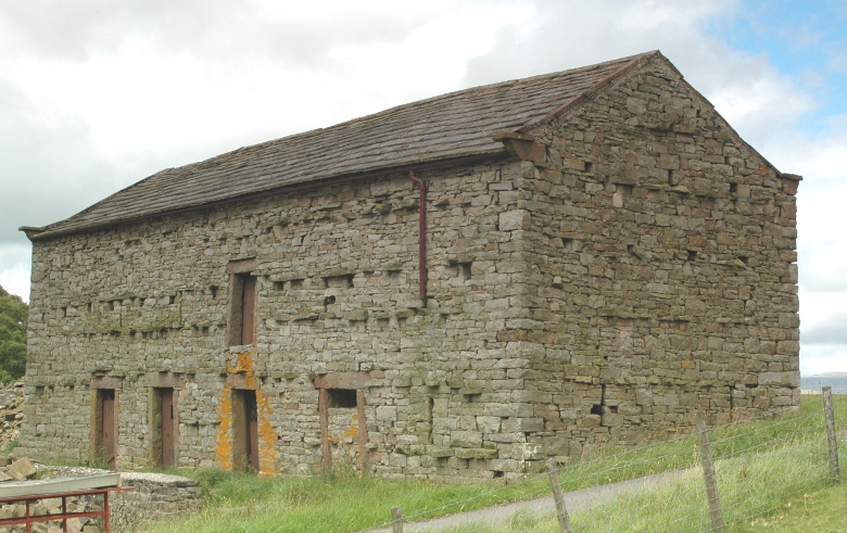 Lower view of stone bank barn in England